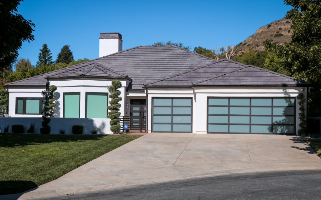 Single-story Southern California home with dark shingle roof installed using roofing and solar financing options