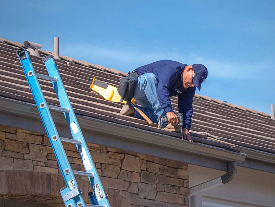 Professional roofer performing roofing repair services on a residential home in Southern California