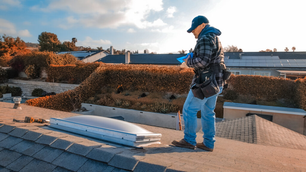 Technician performing Southern California skylights replacement on residential roof