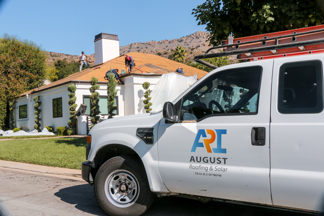 August Roofing crew working on a residential roof