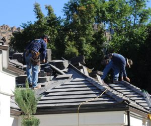 Roofing technicians performing residential roof repair services on a Southern California home