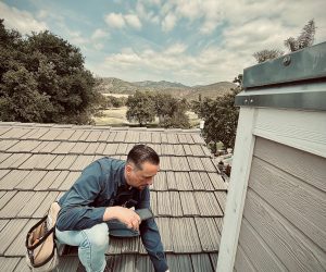Professional roofing inspector checking roof condition during a Southern California roof inspection