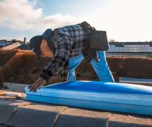 Technician positioning skylight during Southern California skylights replacement service