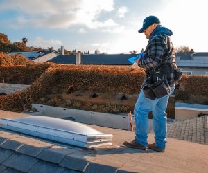 Technician performing Southern California skylights replacement on residential roof