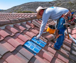 Technician installing an ember-resistant roof vent as part of home hardening and wildfire protection services in Southern California