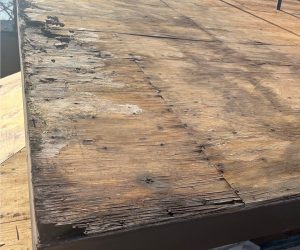 Rotted roof decking along the roof edge caused by prolonged water intrusion and roof leaks in Southern California