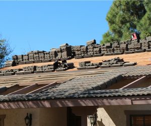 Roof tiles and materials staged during professional roof leak repair and restoration on a Southern California home
